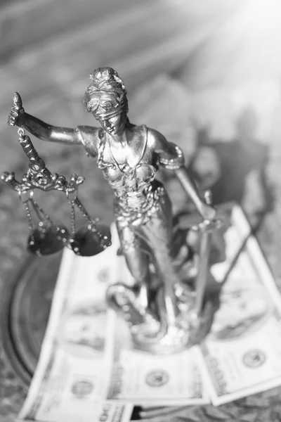 Black and white image of sculpture of themis, femida or justice goddess standing on money bribe symbol of corruption — Stock fotografie