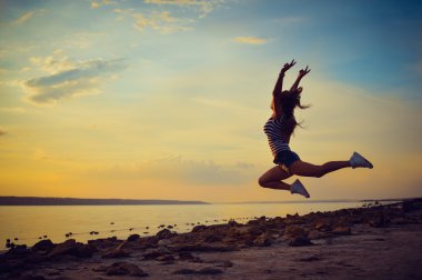Image of beautiful young lady having fun jumping high over open water on summer outdoors background copy space 