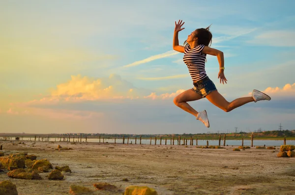 Image of beautiful young lady having fun jumping high over outdoors background copy space — Stok fotoğraf