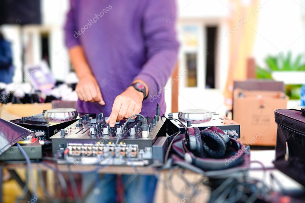 Closeup of djs hands mixing audio tracks with professional  equipment