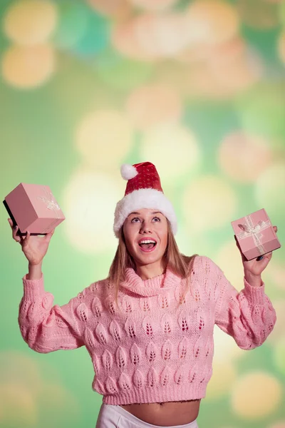 Pretty lady in Santa hat holding two pink gift boxes — Stockfoto