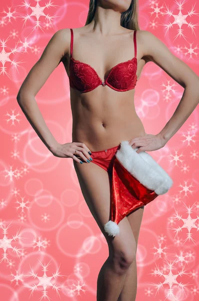 Sexy ladys body with Santa hat on coral bokeh background — Stock Photo, Image