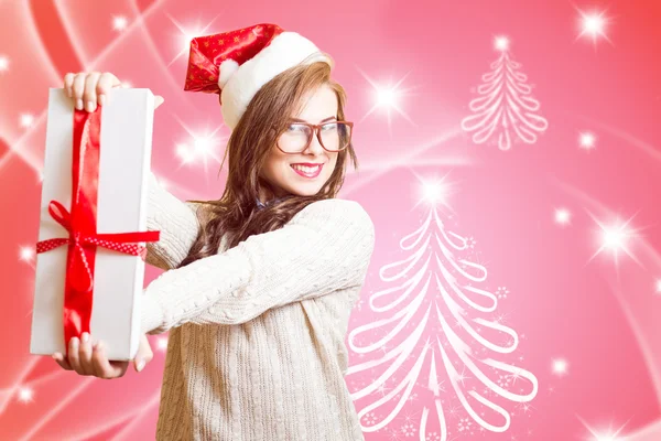 Picture of showing gift box beautiful young woman in Santa red hat and glasses — Stockfoto