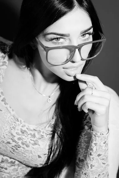 Portrait of young pretty lady in glasses relaxing sitting on chair and flirty looking at camera. Black and white photography — 스톡 사진