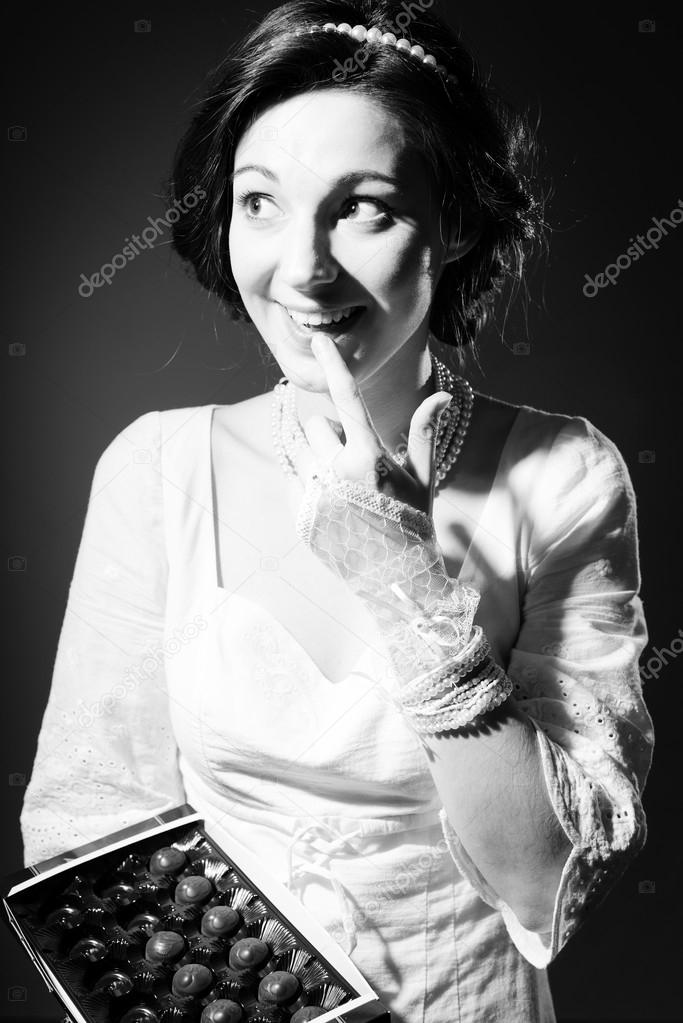 Picture of eating chocolate beautiful young lady having fun happy smile on copy space background. Black and white photography