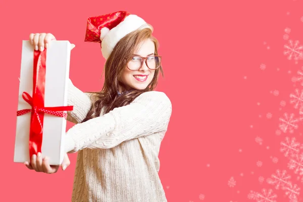 Picture of showing gift box beautiful young woman in Santa red hat and glasses — Stockfoto