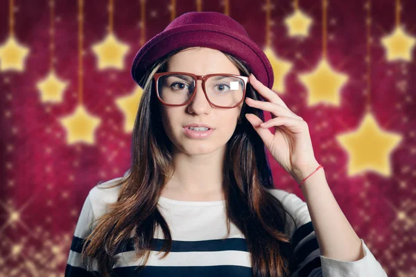 Young attractive lady in hipster glasses on starry purple background — Stock Photo, Image