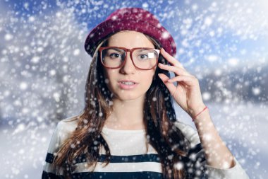Thoughtful young lady wearing fancy hipster glasses and felt hat