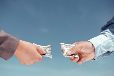 İki erkek eli Doları banknot iki parça halinde parçalıyor