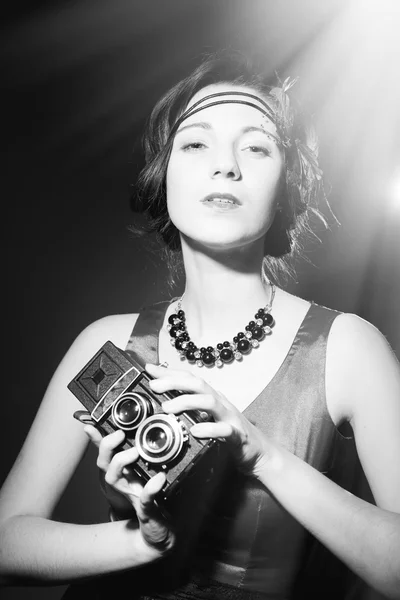Beautiful elegant lady with retro camera. Black and white photography — Zdjęcie stockowe