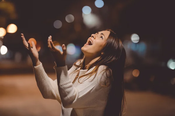 Young brunette lady yelling in despair standing on night street — Stock fotografie