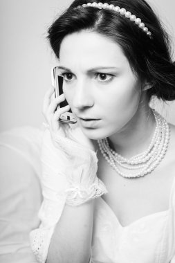 Close up of talking on smart phone beautiful lady looking serious. Black and white photography
