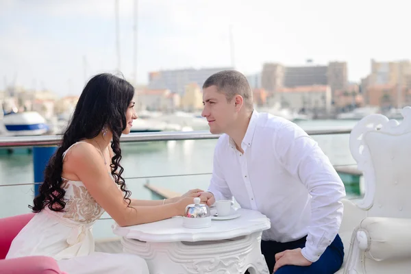 Jovem casal em um restaurante sobre fundo marina — Fotografia de Stock