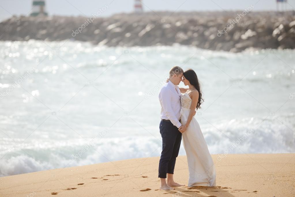 Romantic hugging loving couple on the beach