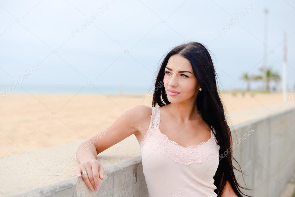 Portrait of pretty girl resting on the embankment