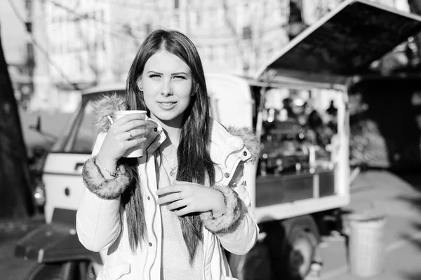 Fotografía en blanco y negro de la joven beata con una taza de bebida caliente al aire libre — Foto de Stock