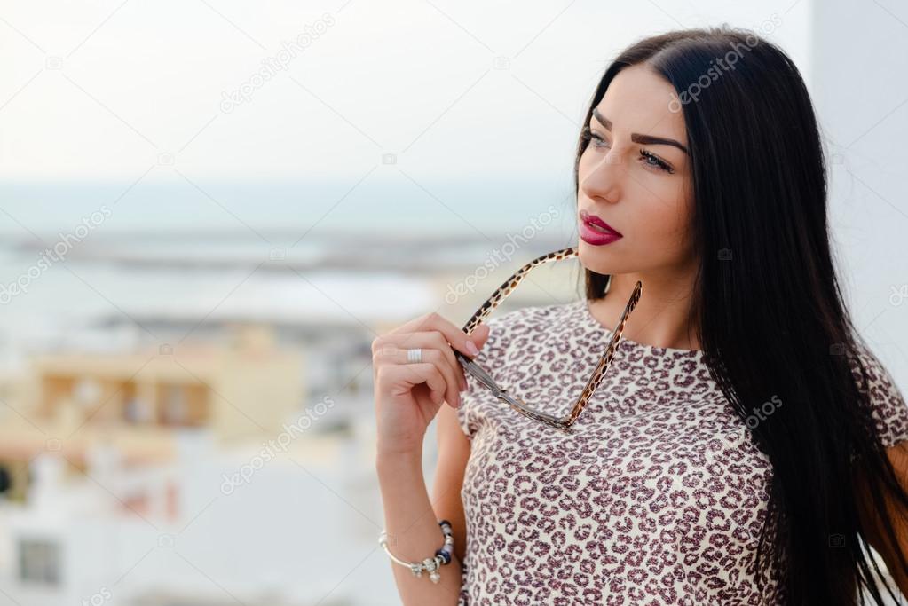 Beautiful gorgeous girl looking over ocean and sky background