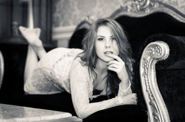 Güzel genç kız kanepe üzerinde yalan rahatlatıcı siyah beyaz fotoğraf