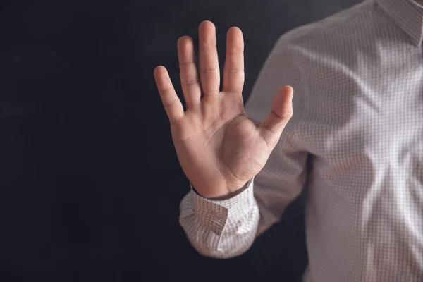 man shows stop with one hand .