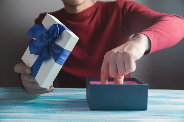 Man Pulls Out Gift Box Table — Stock Photo, Image
