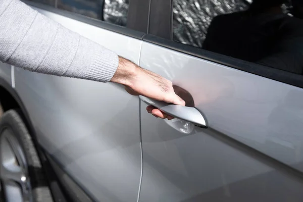 a man opens a car door