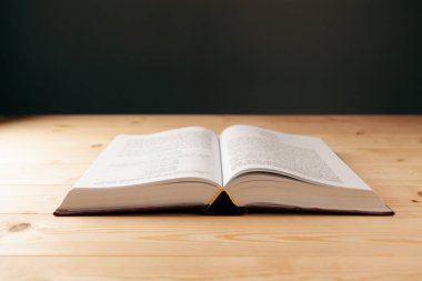 Tahta bir masanın üzerinde açık bir kitap