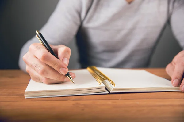 Man Writes Notebook Next Piggy Bank — Stock Photo, Image