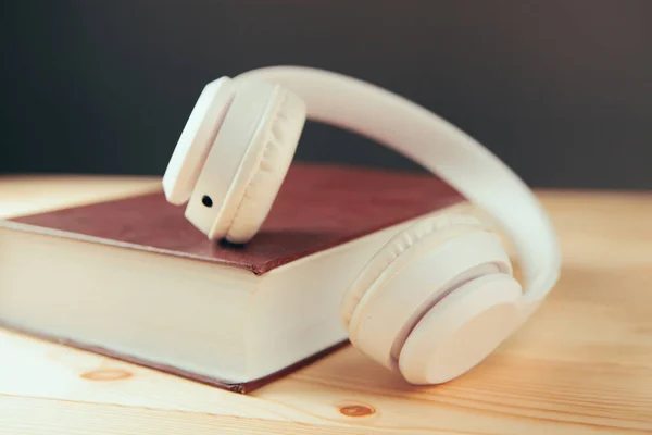 white white headphones on the book and a magnifier