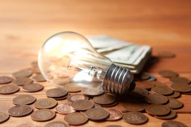 lamp and coins and dollar bills on the table