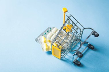 yellow basket with pills on a blue background