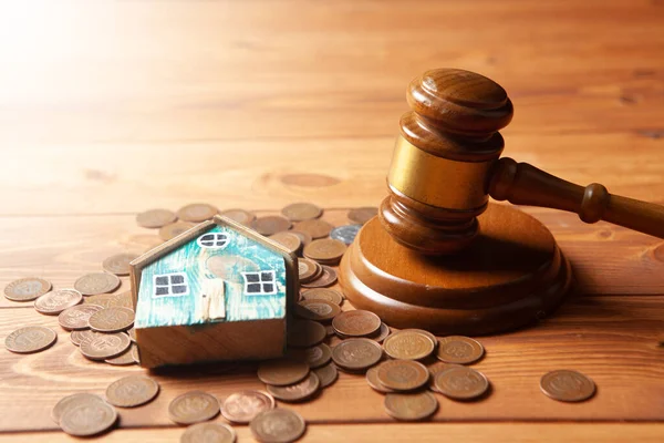 coins under the house and the judge's hammer on the table