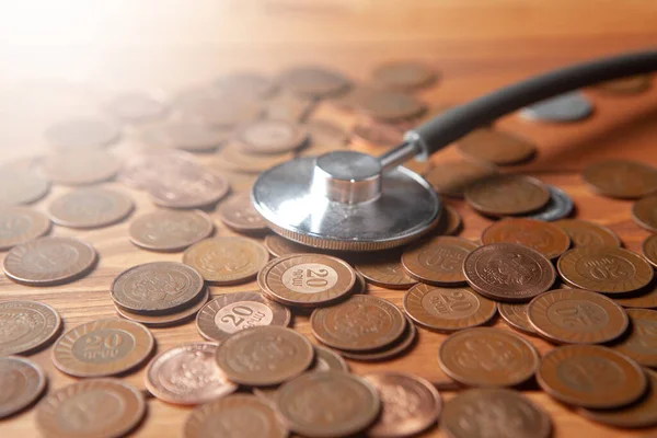 Black Stethoscope Coins Wooden Table — ストック写真