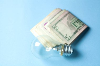 lamp and money on a blue background