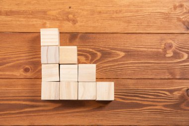 wooden cubes in the form of a ladder on the table