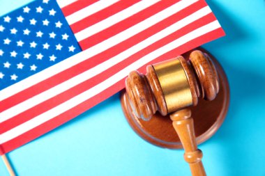 america flag and judge gavel on blue background