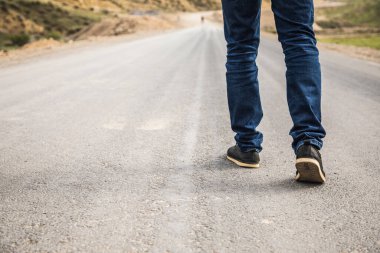 a lonely young man walks the trail