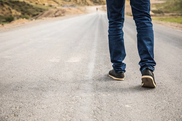 a lonely young man walks the trail