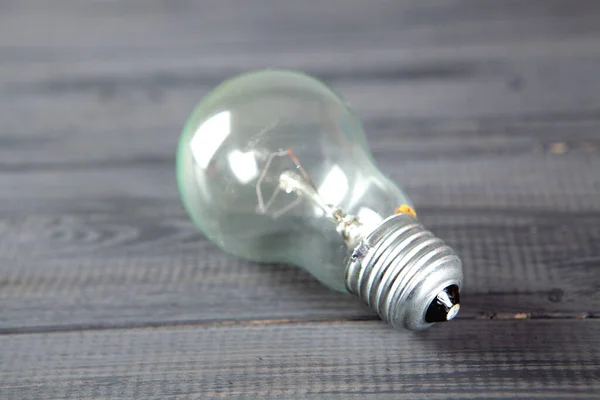 Light Bulb Gray Wooden Background — Stock Photo, Image