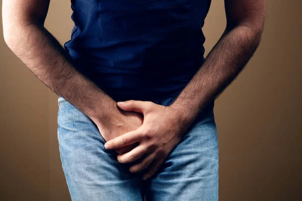 Man Covered His Groin Brown Background — Stock Photo, Image