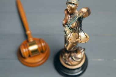 statue of justice and gavel of judge on gray background