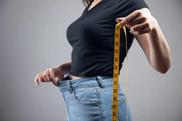 Pulls Jeans Holds Measuring Tape — Stock Photo, Image