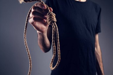 İpi tutan bir adam. İntihar konsepti. gri arkaplanda