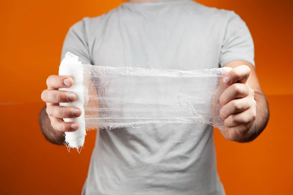 Man Holding Bandage Orange Background — Stock Photo, Image