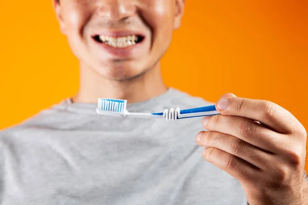 Man Holding Toothbrush Showing Teeth — Stock Photo, Image
