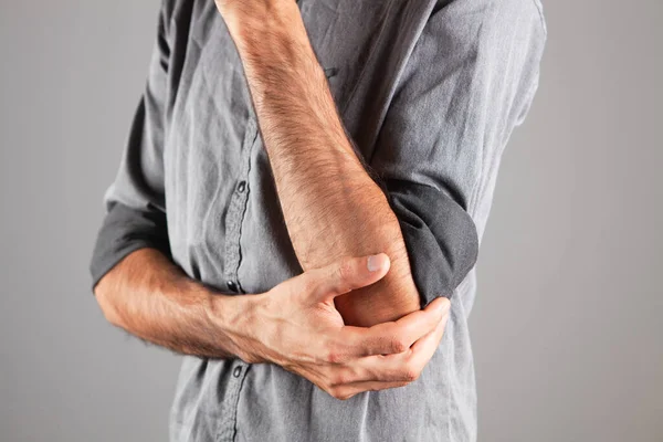Young Guy Has Sore Elbow Gray Background — Stock Photo, Image