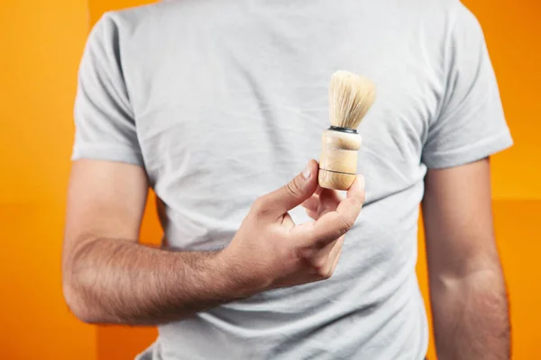 Holding Shaving Brush His Hand Orange Background — Stock Photo, Image