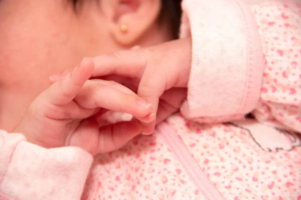 A pair of Hands of a healthy calm and sleeping baby newborn for pediatric care