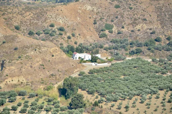 An abandoned small white house in the mountains among the fields. Beautiful top view of a white house in the mountains.