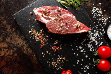 Yangında pişirmek için baharatlı çiğ domuz eti ya da karanlık bir taşta fırın.