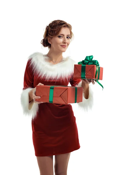 Smiling model posing in studio with gifts. Beautiful Santa Girl. Stock Picture